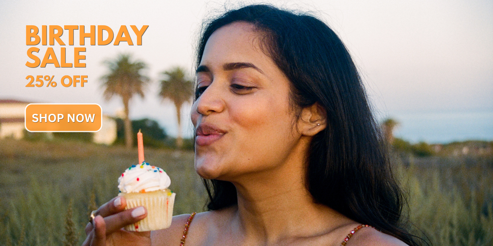 Shavya wears browse clear brow gel and pencil while blowing out a birthday candle on a cupcake.